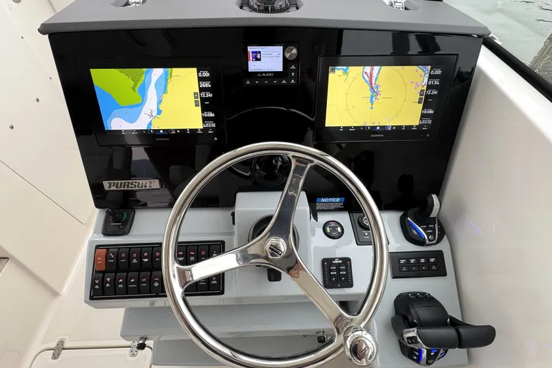 Slide: The Image of 2024 Pursuit DC 326 Dual Console helm with dual Garmin displays and modern controls. - 6