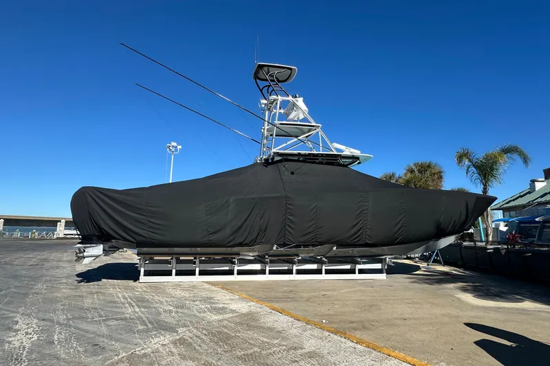 Slide: The Image of 2023 Freeman 42LR boat covered, docked under clear blue sky. - 21