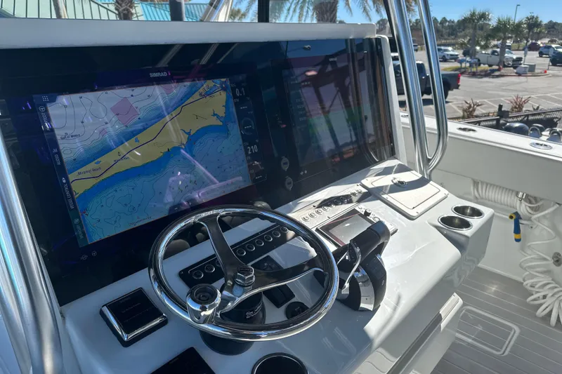 Slide: The Image of 2023 Freeman 42LR boat dashboard with navigation display and steering wheel. - 12