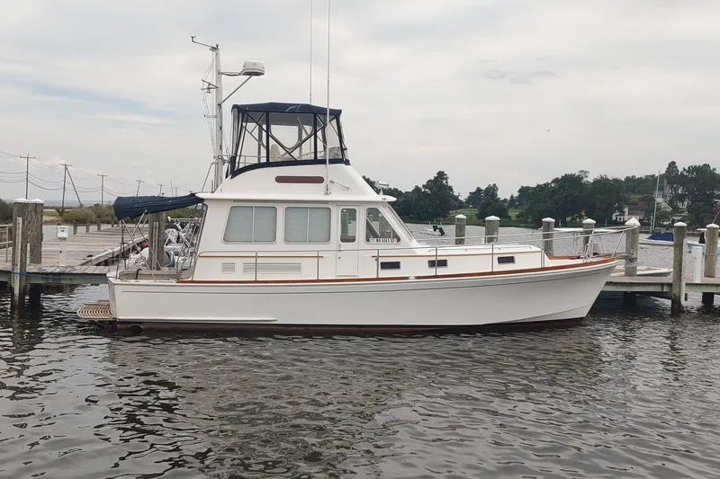 The Image of 1996 Grand Banks 40 Eastbay FB yacht docked at a marina, side view. - 0