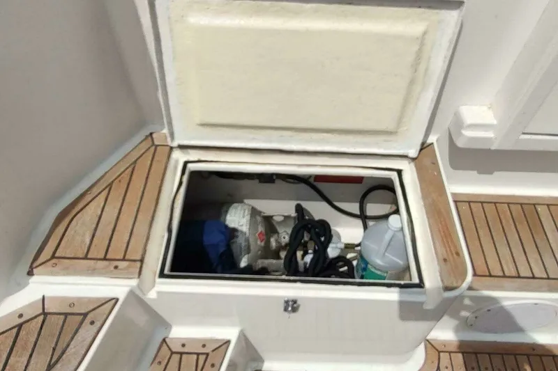 Slide: The Image of Storage compartment on 1996 Grand Banks 40 Eastbay FB with equipment and wooden deck. - 14