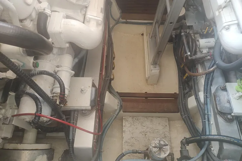 Slide: The Image of Engine room of 1996 Grand Banks 40 Eastbay FB, showcasing mechanical components and wiring. - 79
