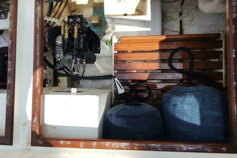 Slide: The Image of 1996 Grand Banks Eastbay 40 Flybridge engine compartment with equipment and storage. - 22