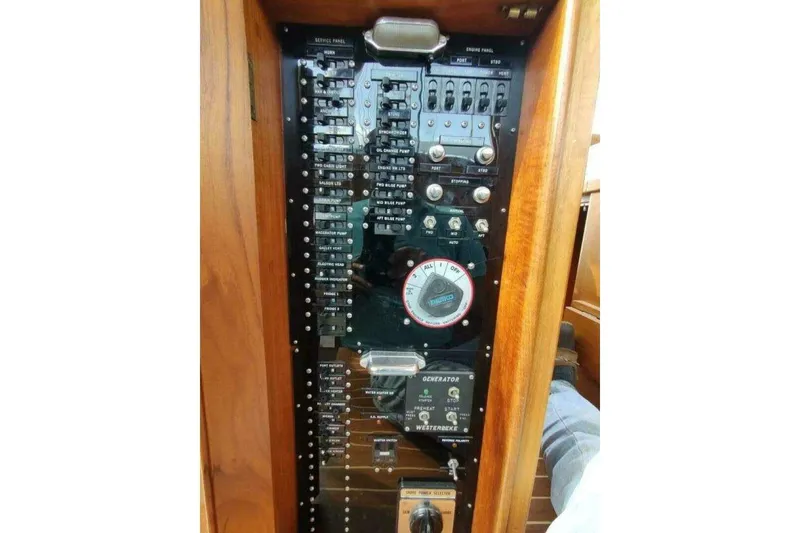 Slide: The Image of Electrical panel of 1996 Grand Banks Eastbay 40 Flybridge boat, featuring switches and gauges. - 39