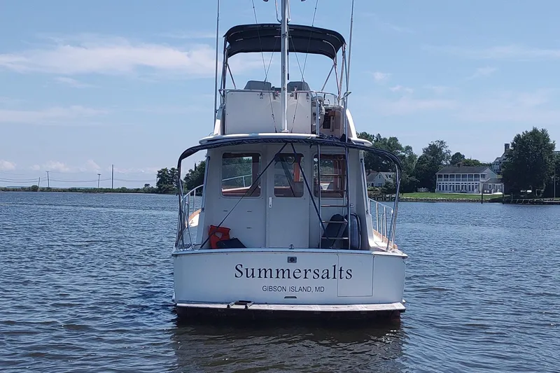 Slide: The Image of Grand Banks Eastbay 40 Flybridge boat on water, rear view, named "Summersalts," Gibson Island, MD. - 4