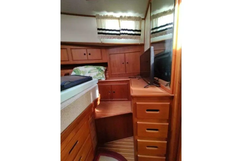 Slide: The Image of 1996 Grand Banks Eastbay 40 Flybridge cabin with wooden interior and TV. - 81