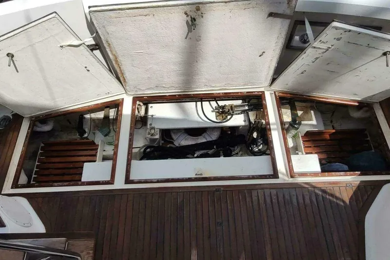 Slide: The Image of Engine compartment of 1996 Grand Banks Eastbay 40 Flybridge with open hatches and visible components. - 19