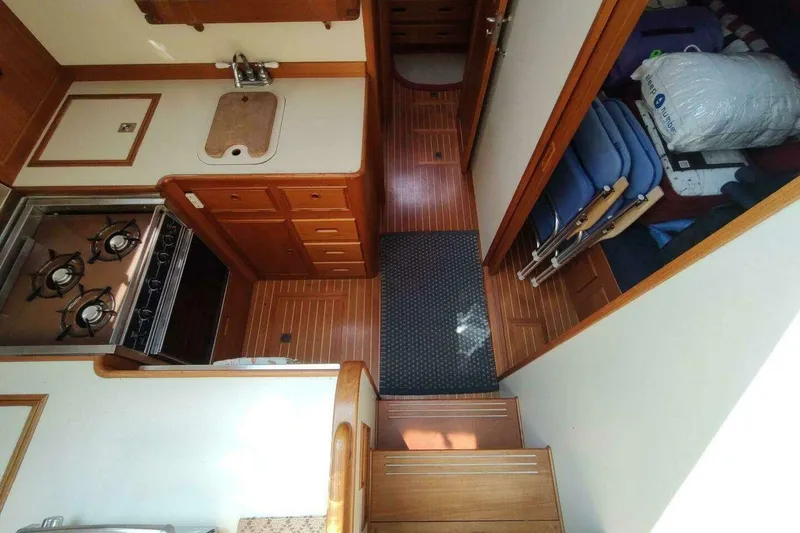 Slide: The Image of 1996 Grand Banks Eastbay 40 Flybridge interior with kitchen, stove, and storage area. - 55