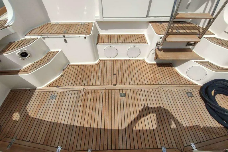 Slide: The Image of Teak deck of 1996 Grand Banks Eastbay 40 Flybridge with steps and storage compartments. - 15