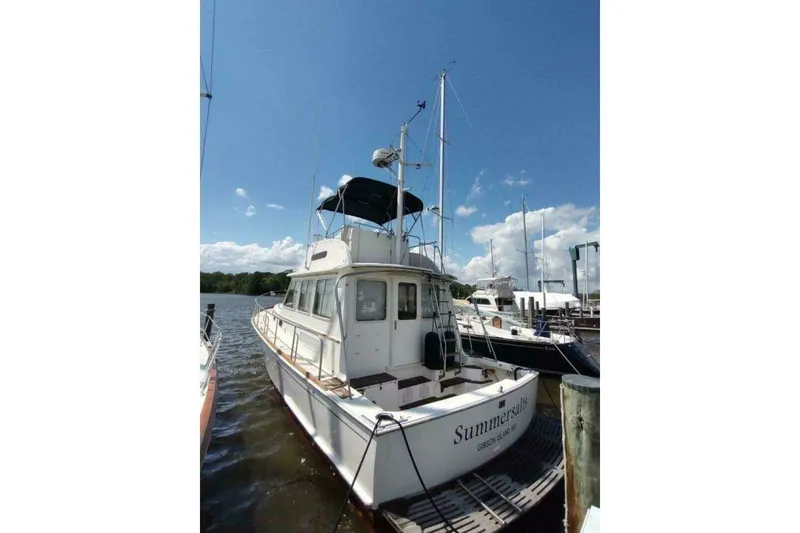 Slide: The Image of 1996 Grand Banks Eastbay 40 Flybridge docked under a clear blue sky. - 10