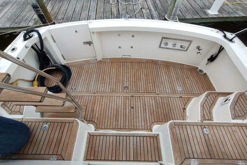 Slide: The Image of 1996 Grand Banks Eastbay 40 Flybridge teak deck with steps and railing, dockside view. - 16