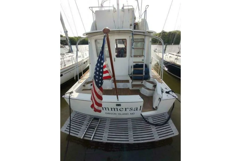 Slide: The Image of 1996 Grand Banks Eastbay 40 Flybridge yacht with American flag, docked at Gibson Island, MD. - 12