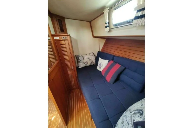 Slide: The Image of Cozy cabin interior of 1996 Grand Banks Eastbay 40 Flybridge with nautical-themed cushions. - 75