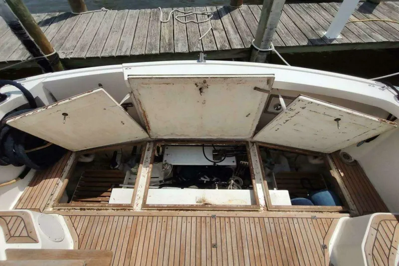 Slide: The Image of 1996 Grand Banks Eastbay 40 Flybridge engine compartment with open hatches, docked at marina. - 18