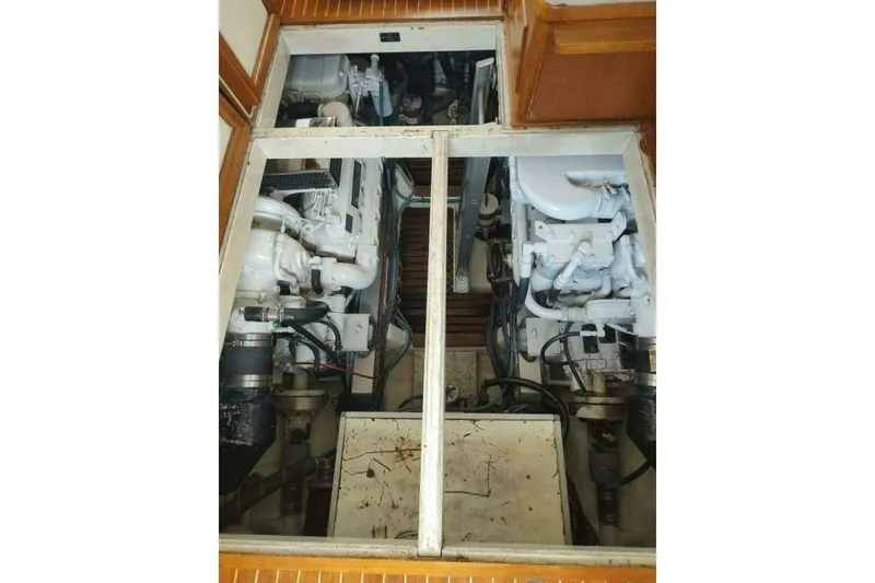 Slide: The Image of Engine room of 1996 Grand Banks Eastbay 40 Flybridge, showcasing dual engines and mechanical components. - 90