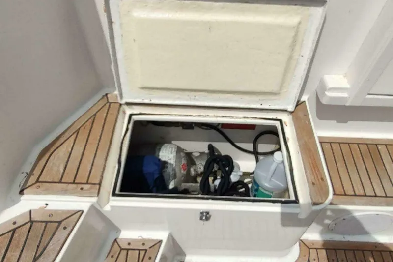Slide: The Image of Open storage compartment on 1996 Grand Banks Eastbay 40 Flybridge boat deck. - 23