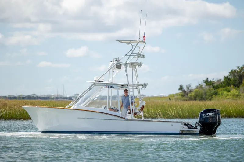 Slide: The Image of Custom Carolina 26 Tideline Boatworks Express 2005 cruising on a calm waterway. - 3