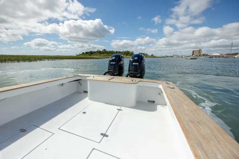 Slide: The Image of Custom Carolina 26 Tideline Boatworks Express, 2005, with dual engines on open water. - 17