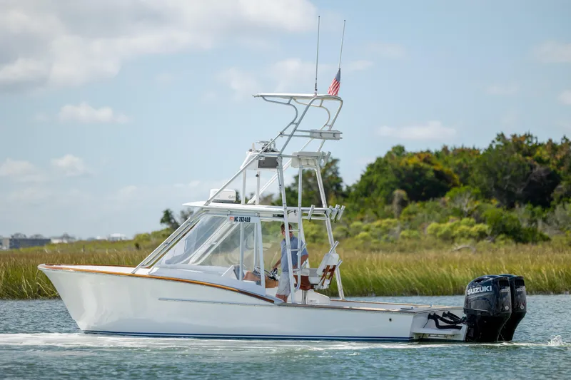 Slide: The Image of 2005 Custom Carolina 26 Tideline Boatworks Express cruising on a scenic waterway. - 1