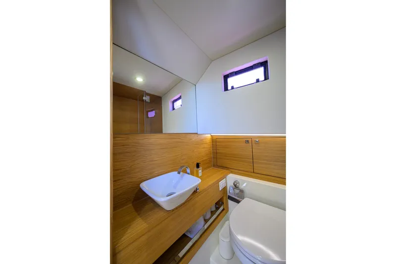 Slide: The Image of Modern bathroom interior on 2023 De Antonio Yachts D42 Open, featuring sleek wood finishes. - 32