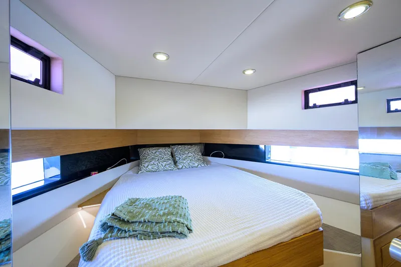 Slide: The Image of Luxurious cabin interior of 2023 De Antonio Yachts D42 Open, featuring a cozy bed and modern design. - 23
