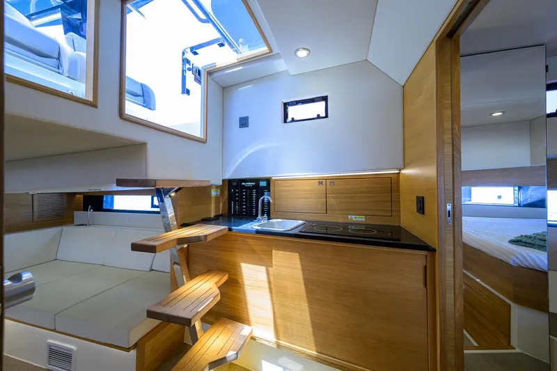 Slide: The Image of Interior of 2023 De Antonio Yachts D42 Open, featuring modern kitchen and seating area. - 30