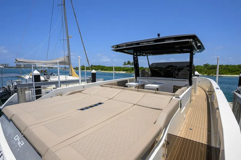 Slide: The Image of 2023 De Antonio Yachts D42 Open with spacious deck, docked by serene waters. - 11