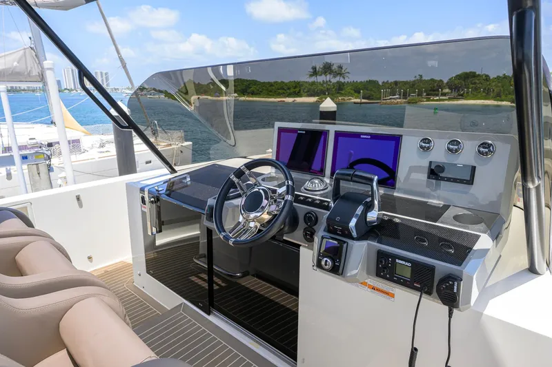 Slide: The Image of Helm of 2023 De Antonio Yachts D42 Open, featuring modern controls and navigation screens. - 39