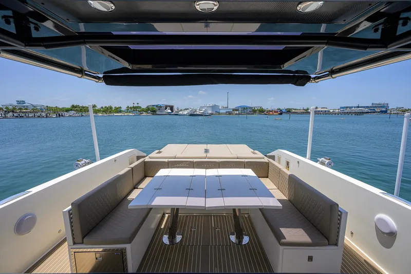 Slide: The Image of Luxury seating area on 2023 De Antonio Yachts D42 Open, overlooking serene waterfront. - 16