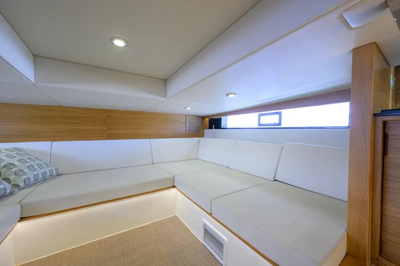 Slide: The Image of Luxurious interior of 2023 De Antonio Yachts D42 Open with white seating and wood accents. - 44