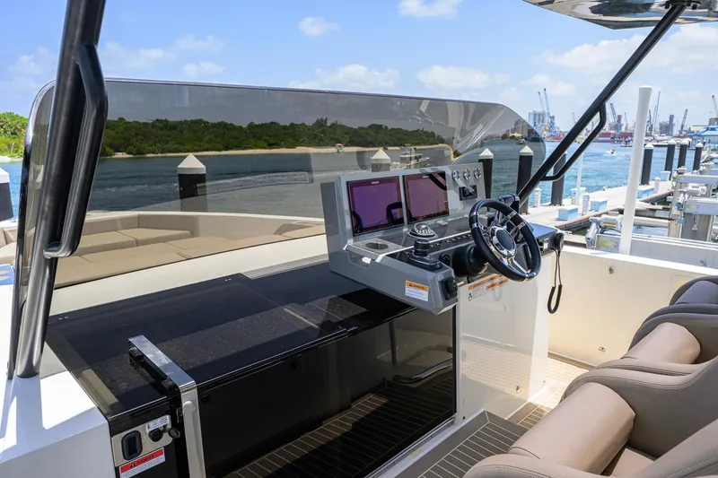 Slide: The Image of 2023 De Antonio Yachts D42 Open helm with modern controls and scenic marina view. - 36