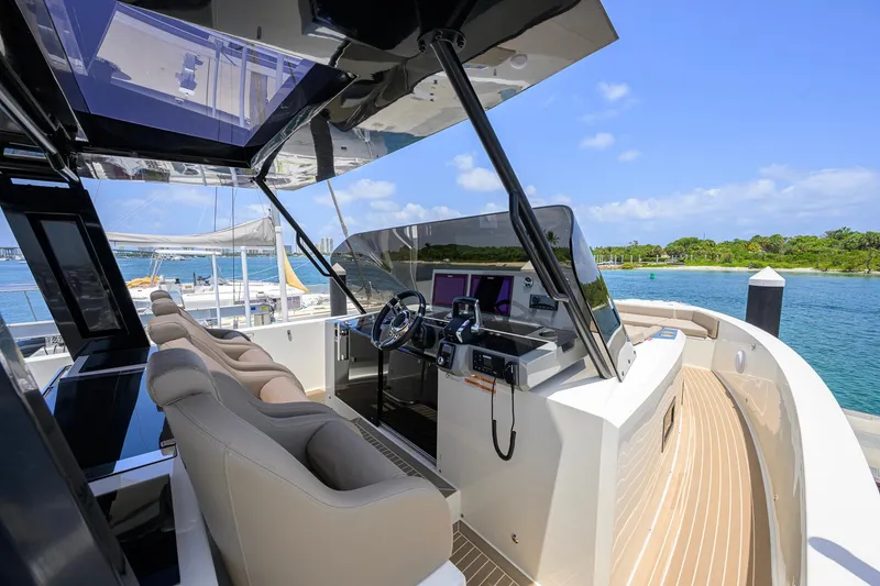 Slide: The Image of Luxurious 2023 De Antonio Yachts D42 Open cockpit with plush seating and scenic waterfront view. - 40