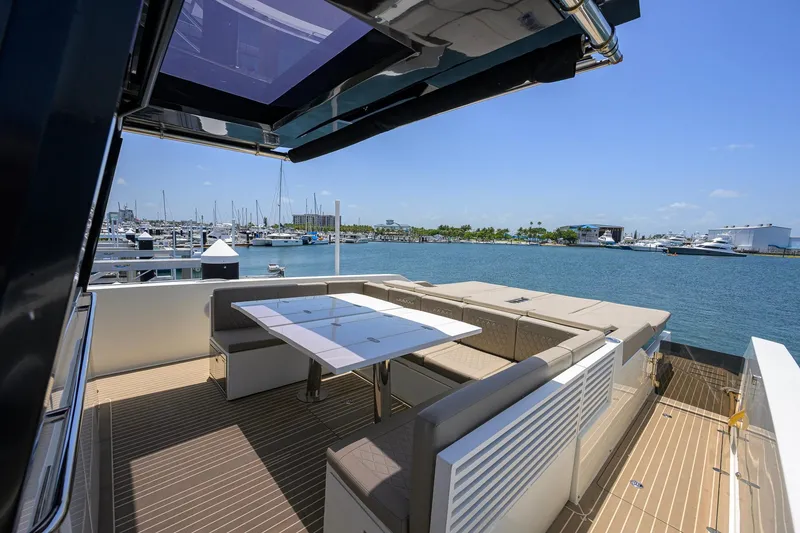 Slide: The Image of 2023 De Antonio Yachts D42 Open, featuring a luxurious deck with seating and marina view. - 17