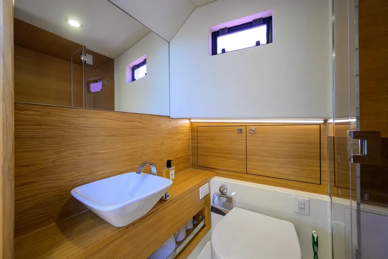 Slide: The Image of Luxurious bathroom interior of 2023 De Antonio Yachts D42 Open, featuring modern wood finishes. - 33