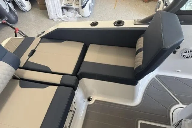 Slide: The Image of 2026 Monterey Elite 25 OB boat interior with cushioned seating and modern design. - 23