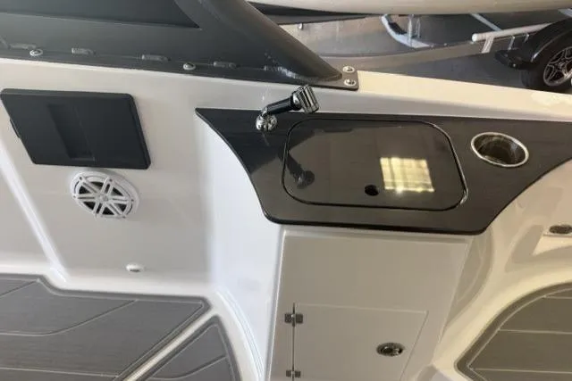 Slide: The Image of Interior view of 2026 Monterey Elite 25 OB boat, featuring a sleek sink and speaker system. - 21