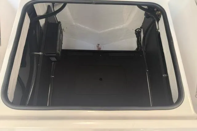 Slide: The Image of Open storage compartment of 2026 Monterey Elite 25 OB boat, showcasing interior space. - 6