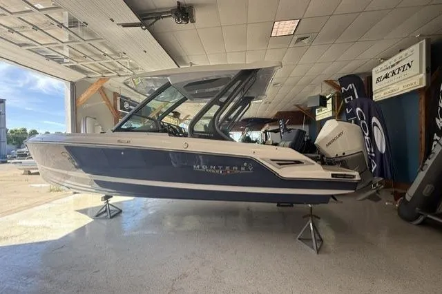The Image of 2026 Monterey Elite 25 OB boat displayed indoors, showcasing sleek design and modern features. - 0