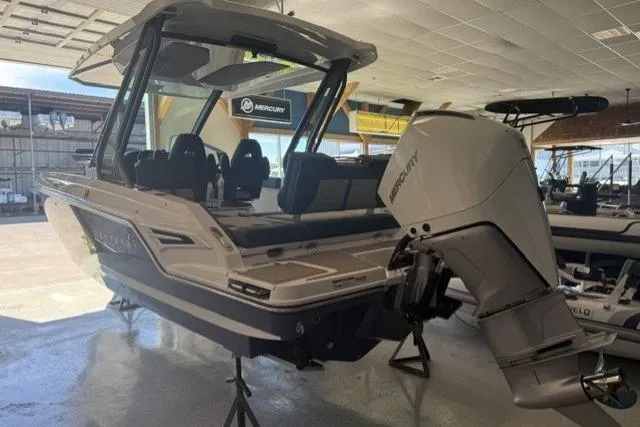 Slide: The Image of 2026 Monterey Elite 25 OB boat with Mercury outboard engine in showroom. - 4