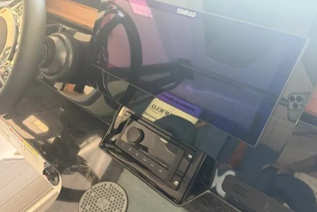 Slide: The Image of Dashboard of a 2026 Monterey Elite 25 OB boat with Simrad display and controls. - 16