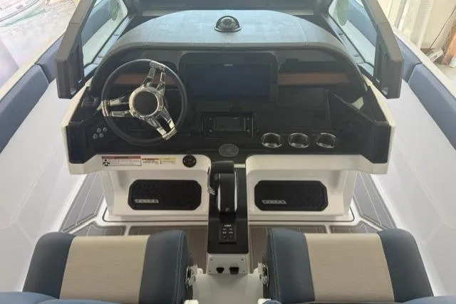 Slide: The Image of Cockpit of 2026 Monterey Elite 25 OB boat with modern steering and controls. - 19