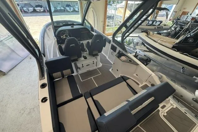 Slide: The Image of 2026 Monterey Elite 25 OB boat interior with modern seating and sleek design. - 25