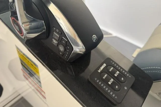 Slide: The Image of Control panel of 2026 Monterey Elite 25 OB boat with throttle and trim tab switches. - 17