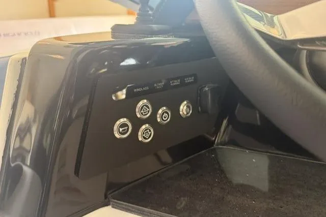 Slide: The Image of Control panel of 2026 Monterey Elite 25 OB boat with various function buttons. - 18
