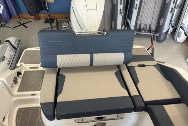 Slide: The Image of 2026 Monterey Elite 25 OB boat interior with cushioned seating and modern design. - 24