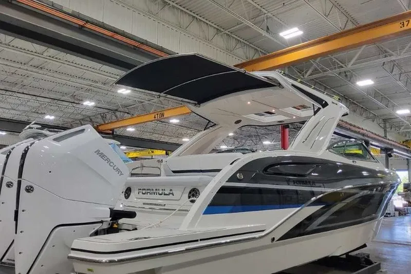 Slide: The Image of 2027 Formula 360 Crossover Bowrider OB in a showroom, featuring Mercury outboard engines. - 59