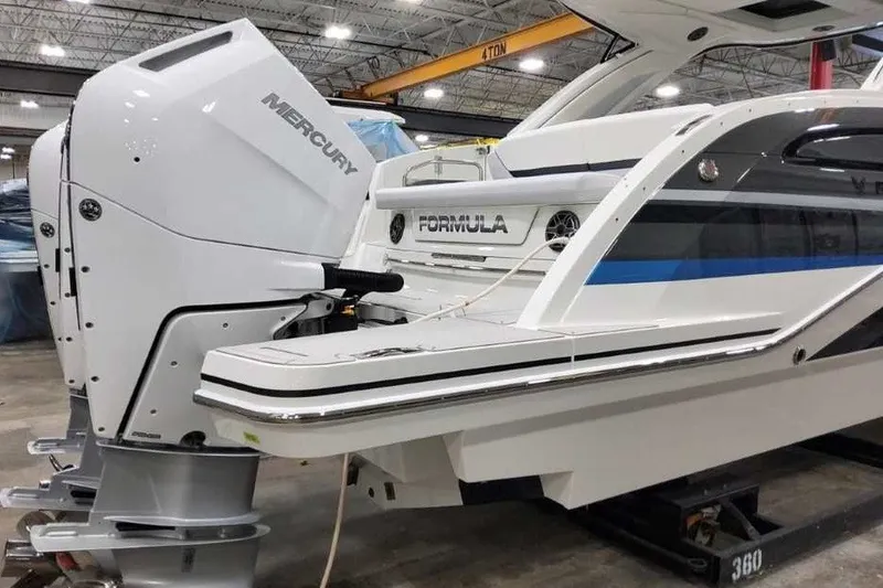 Slide: The Image of 2027 Formula 360 Crossover Bowrider OB with Mercury outboard engine in a showroom. - 6