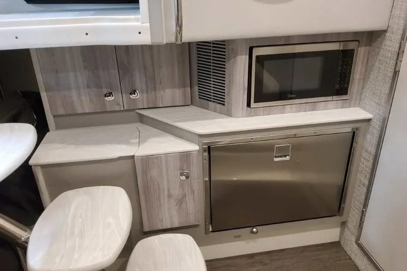 Slide: The Image of 2027 Formula 360 Crossover Bowrider OB interior with microwave and storage cabinets. - 69