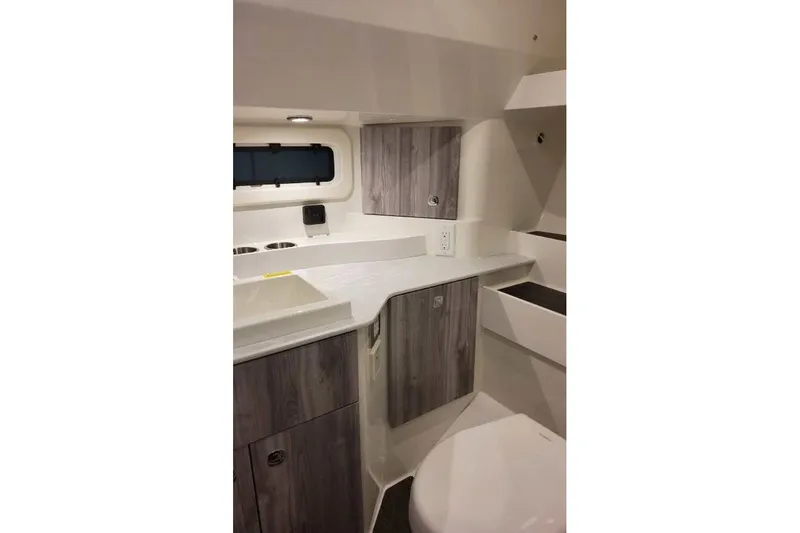 Slide: The Image of Interior of 2027 Formula 360 Crossover Bowrider OB, featuring modern cabinetry and compact design. - 73