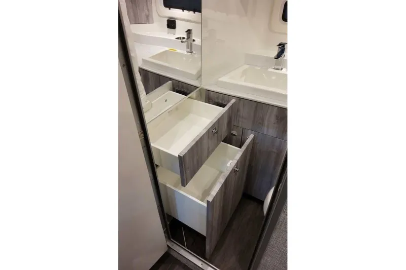 Slide: The Image of Interior of 2027 Formula 360 Crossover Bowrider OB, featuring modern cabinetry and sink. - 77